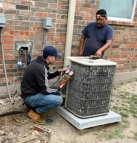 Two of our Air Zone Experts perform annual maintenance on an HVAC unit.